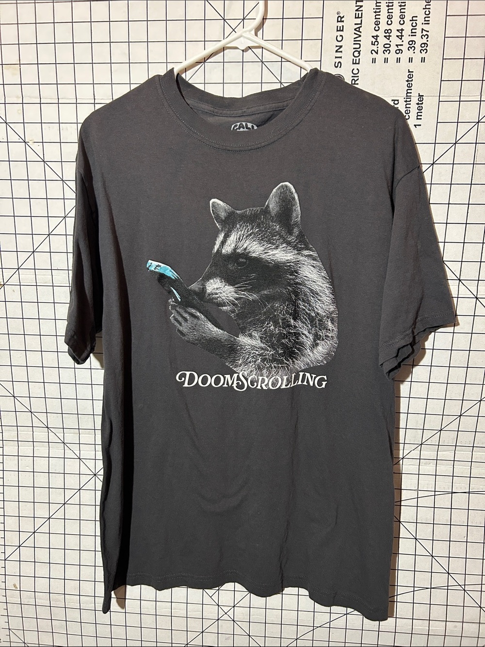 Call Your Mother Men's Black 'Doomscrolling' Graphic Tee - Raccoon Phone Design